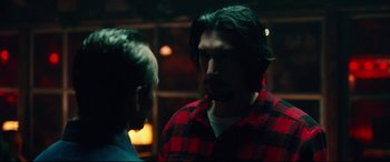 Movie still from “BlacKkKlansman” (2018), directed by Spike Lee – A man wearing a red and black shirt talking to another man; Medium shot, Over the shoulder angle