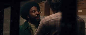 Movie still from “BlacKkKlansman” (2018), directed by Spike Lee – A man with a beard talking to another man; Close Up shot, Over the shoulder angle
