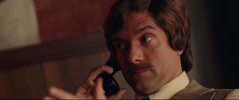 Movie still from “BlacKkKlansman” (2018), directed by Spike Lee – A person talking on a cell phone; Close Up shot, Low angle