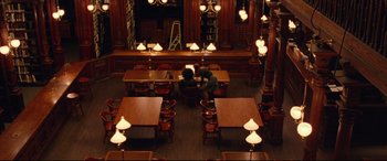 Movie still from “BlacKkKlansman” (2018), directed by Spike Lee – Two people are sitting at a table in a library; Extreme Wide shot, High angle