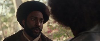 Movie still from “BlacKkKlansman” (2018), directed by Spike Lee – A person with a beard; Close Up shot, Over the shoulder angle