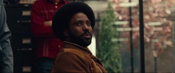 Movie still from “BlacKkKlansman” (2018), directed by Spike Lee – A person with a beard; Close Up shot, Over the shoulder angle
