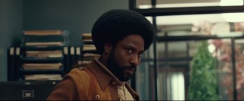 Movie still from “BlacKkKlansman” (2018), directed by Spike Lee – A person wearing a jacket; Close Up shot, Low angle