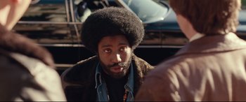 Movie still from “BlacKkKlansman” (2018), directed by Spike Lee – A person with a beard; Close Up shot, Over the shoulder angle