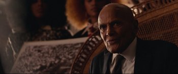 Movie still from “BlacKkKlansman” (2018), directed by Spike Lee – An older man wearing a suit and tie; Close Up shot, Over the shoulder angle