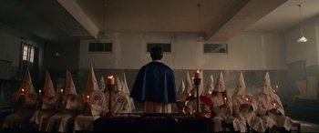 Movie still from “BlacKkKlansman” (2018), directed by Spike Lee – A man standing in front of a group of people; Wide shot, High angle