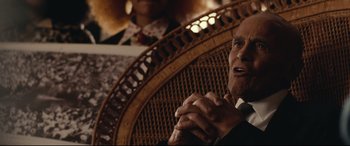 Movie still from “BlacKkKlansman” (2018), directed by Spike Lee – An older man sitting in a chair with his hands clasped together; Close Up shot, Over the shoulder angle