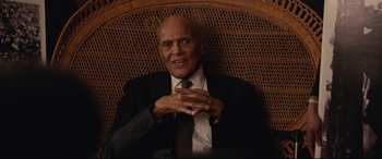 Movie still from “BlacKkKlansman” (2018), directed by Spike Lee – An older man wearing a suit and a tie; Medium shot, Low angle