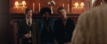Movie still from “BlacKkKlansman” (2018), directed by Spike Lee – A group of men standing next to each other in front of candles; Medium shot, Over the shoulder angle