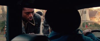 Movie still from “BlacKkKlansman” (2018), directed by Spike Lee – A man looking into a mirror while talking on the phone; Close Up shot, Over the shoulder angle