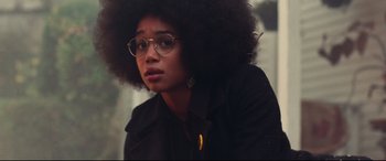Movie still from “BlacKkKlansman” (2018), directed by Spike Lee – A woman with glasses and a black jacket; Close Up shot, Low angle