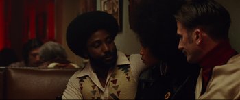 Movie still from “BlacKkKlansman” (2018), directed by Spike Lee – A man and a woman sitting next to each other in a room; Close Up shot, Over the shoulder angle
