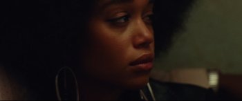 Movie still from “BlacKkKlansman” (2018), directed by Spike Lee – A person with headphones on; Close Up shot, Low angle