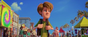Movie still from “Scoob!” (2020), directed by Tony Cervone – A cartoon of a boy with a backpack and headphones; Medium shot, Over the shoulder angle