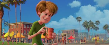 Movie still from “Scoob!” (2020), directed by Tony Cervone – A man holding a hot dog in his hand; Medium shot, Over the shoulder angle