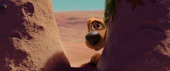 Movie still from “Scoob!” (2020), directed by Tony Cervone – A cartoon dog looking up at a tree in the desert; Close Up shot, High angle
