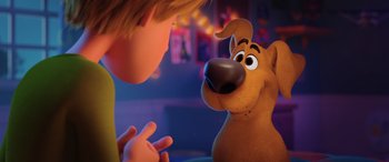 Movie still from “Scoob!” (2020), directed by Tony Cervone – A boy and a dog in a scene from the movie scoob; Close Up shot, Over the shoulder angle