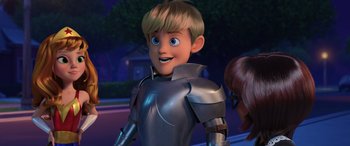 Movie still from “Scoob!” (2020), directed by Tony Cervone – A boy is dressed in a suit of armor and smiling; Medium shot, Over the shoulder angle