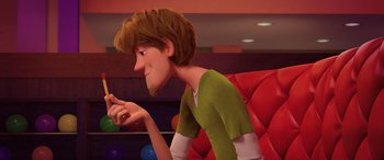 Movie still from “Scoob!” (2020), directed by Tony Cervone – A cartoon of a person looking at a cell phone; Close Up shot, Over the shoulder angle