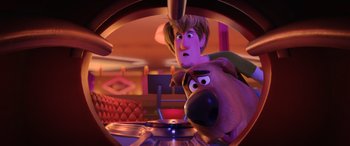 Movie still from “Scoob!” (2020), directed by Tony Cervone – A man and a scooby - doo dog in a room; Medium shot, Over the shoulder angle