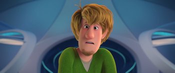Movie still from “Scoob!” (2020), directed by Tony Cervone – A cartoon of a man with blonde hair and a green shirt; Close Up shot, Low angle