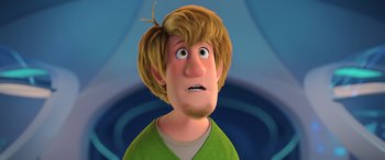 Movie still from “Scoob!” (2020), directed by Tony Cervone – A cartoon of a man with blonde hair and a green shirt; Close Up shot, Over the shoulder angle