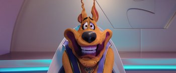 Movie still from “Scoob!” (2020), directed by Tony Cervone – A scooby - doo character is smiling for the camera; Close Up shot, Low angle