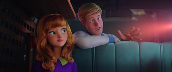 Movie still from “Scoob!” (2020), directed by Tony Cervone – A girl and a boy sitting in a car together; Close Up shot, Over the shoulder angle
