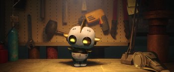 Movie still from “Scoob!” (2020), directed by Tony Cervone – A small toy character is standing in front of a work bench; Wide shot, High angle