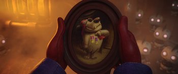 Movie still from “Scoob!” (2020), directed by Tony Cervone – A person holding a picture of a dog with a medal on it; Medium shot, Over the shoulder angle
