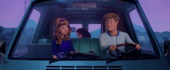 Movie still from “Scoob!” (2020), directed by Tony Cervone – A couple of people sitting in the back of a car; Medium shot, Over the shoulder angle