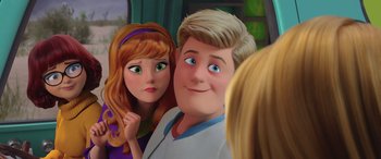 Movie still from “Scoob!” (2020), directed by Tony Cervone – A couple of people standing next to each other in a room; Close Up shot, Over the shoulder angle