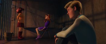 Movie still from “Scoob!” (2020), directed by Tony Cervone – A girl and a boy sitting on a chair in a dark room; Wide shot, Over the shoulder angle