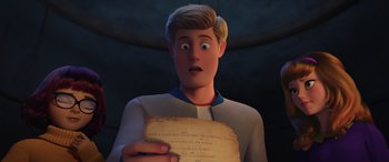 Movie still from “Scoob!” (2020), directed by Tony Cervone – A man is holding a piece of paper in his hand; Close Up shot, Over the shoulder angle