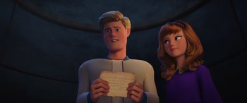 Movie still from “Scoob!” (2020), directed by Tony Cervone – A man and a woman holding a piece of paper; Close Up shot, Over the shoulder angle