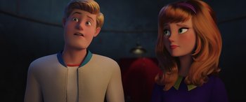 Movie still from “Scoob!” (2020), directed by Tony Cervone – A man and a woman standing next to each other; Close Up shot, Over the shoulder angle