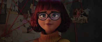 Movie still from “Scoob!” (2020), directed by Tony Cervone – A cartoon girl with glasses is looking at the camera; Close Up shot, Low angle