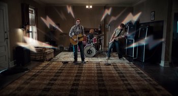 Movie still from “Scott Pilgrim vs. the World” (2010), directed by Edgar Wright – A group of people playing a rock band in a living room; Wide shot, High angle