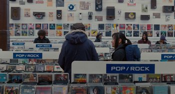 Movie still from “Scott Pilgrim vs. the World” (2010), directed by Edgar Wright – A group of people standing in front of a wall of cds; Wide shot, Over the shoulder angle