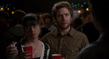 Movie still from “Scott Pilgrim vs. the World” (2010), directed by Edgar Wright – A man and a woman standing next to each other holding cups; Close Up shot, Over the shoulder angle