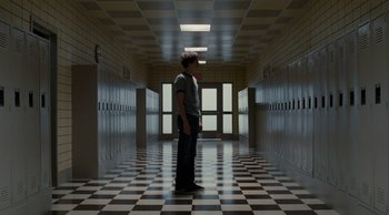 Movie still from “Scott Pilgrim vs. the World” (2010), directed by Edgar Wright – A man standing in a hallway of a school; Wide shot, Low angle