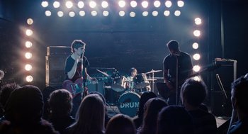 Movie still from “Scott Pilgrim vs. the World” (2010), directed by Edgar Wright – A group of young people playing a concert in front of an audience; Wide shot, High angle