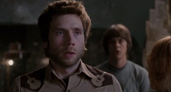 Movie still from “Scott Pilgrim vs. the World” (2010), directed by Edgar Wright – A man standing next to another man in a dark room; Close Up shot, Over the shoulder angle