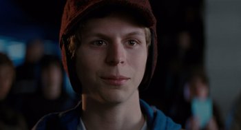 Movie still from “Scott Pilgrim vs. the World” (2010), directed by Edgar Wright – A young man wearing a red hat and looking at the camera; Close Up shot, Over the shoulder angle