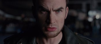 Movie still from “Scott Pilgrim vs. the World” (2010), directed by Edgar Wright – A man's face with a dark background; Close Up shot, Low angle