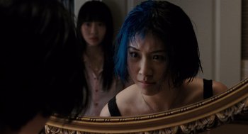 Movie still from “Scott Pilgrim vs. the World” (2010), directed by Edgar Wright – A woman with blue hair looking in the mirror; Close Up shot, Over the shoulder angle