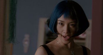 Movie still from “Scott Pilgrim vs. the World” (2010), directed by Edgar Wright – A woman with blue hair is smiling for the camera; Close Up shot, Over the shoulder angle