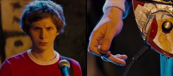 Movie still from “Scott Pilgrim vs. the World” (2010), directed by Edgar Wright – A young man holding a microphone in front of an audience; Close Up shot, Over the shoulder angle