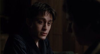 Movie still from “Scott Pilgrim vs. the World” (2010), directed by Edgar Wright – A young man sitting in front of a wooden wall; Close Up shot, Over the shoulder angle