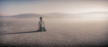 Movie still from “Scott Pilgrim vs. the World” (2010), directed by Edgar Wright – A person sitting in the middle of an empty field; Wide shot, High angle